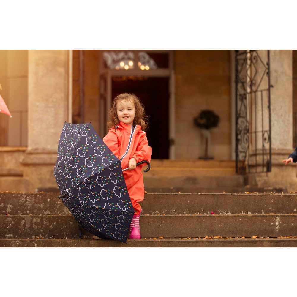 little girl holding colour changing umbrella - grass and air
