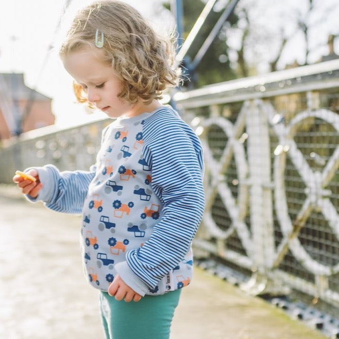little girl wearing Tractor Sweatshirt from Toucan Blue | Cotswold Baby Co