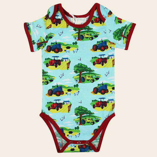Baby onesie with tractor pattern on a white background