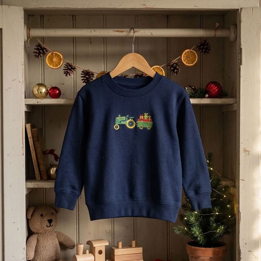 a navy sweater hanging up in a wardobe surrounded by christmas decorations