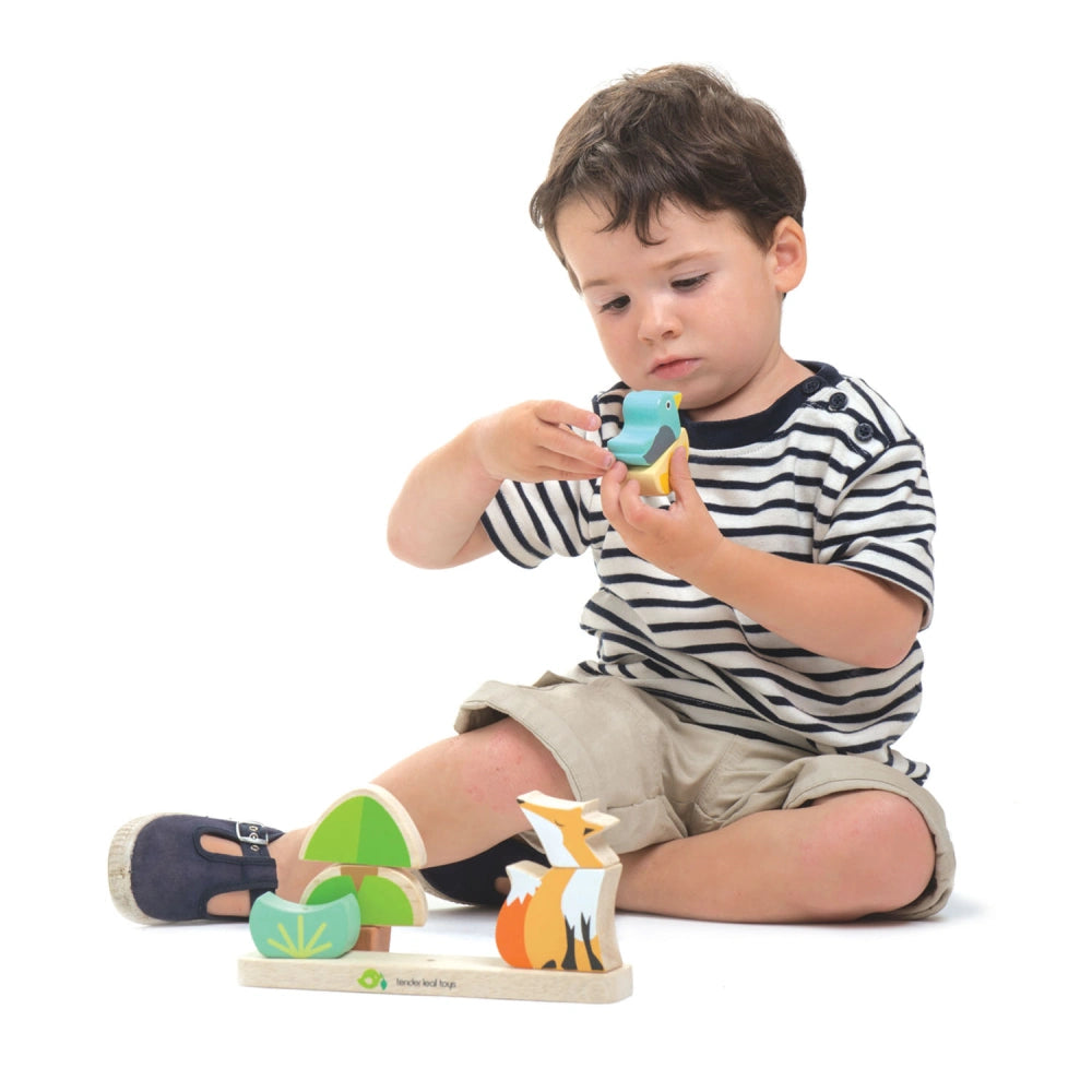 Boy playing with wooden toy