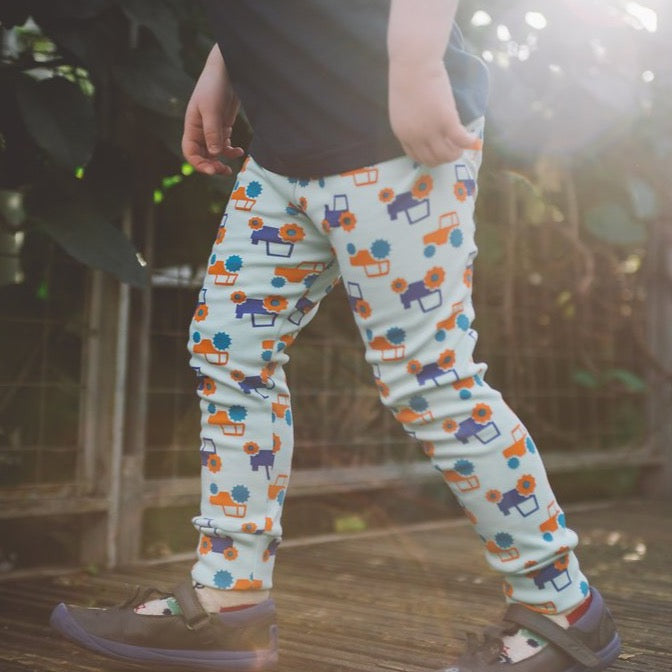 toddler wearing aqua cuffed tractor leggings | Cotswold Baby Co