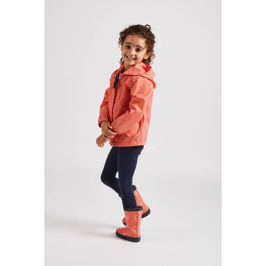 Girl wearing coral rain cheater waterproof coat by Grass and Air - Cotswold Baby Co