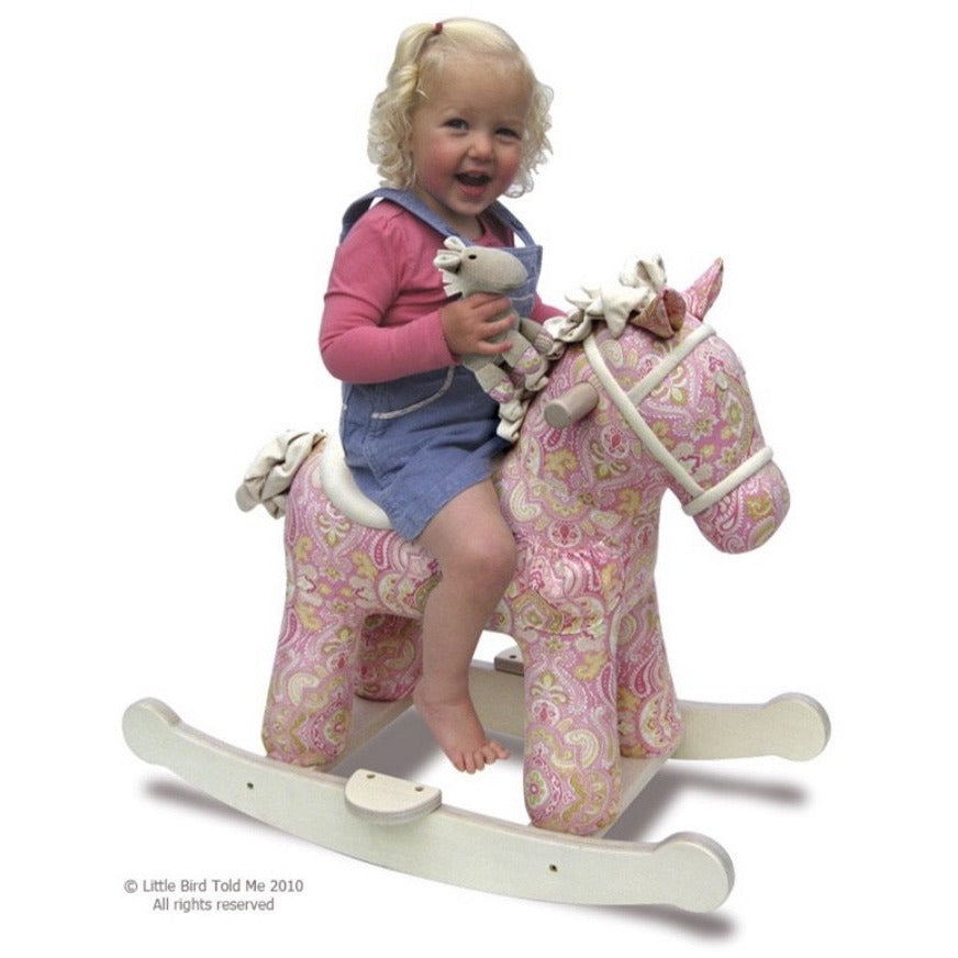 child riding Pixie & Fluff Rocking Horse by Little Bird Told Me | Cotswold Baby Co