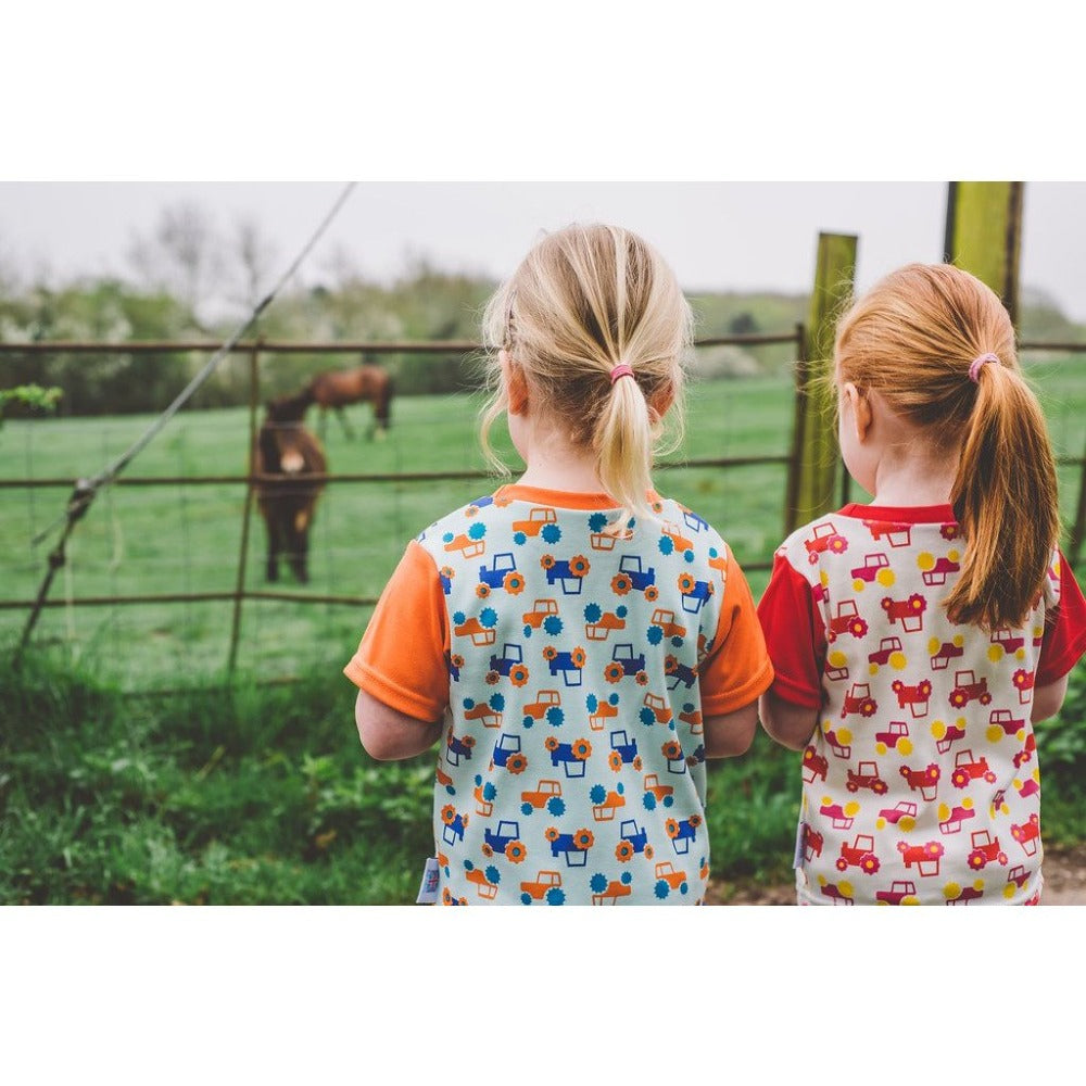 Little Girl wearing Orange & Aqua Tractor T-shirt by Toucan Blue | Cotswold Baby co
