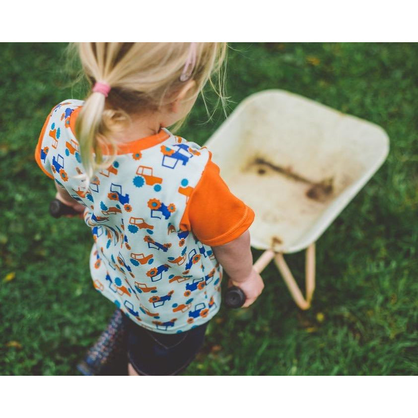 Little Girl wearing Orange & Aqua Tractor T-shirt by Toucan Blue | Cotswold Baby co 