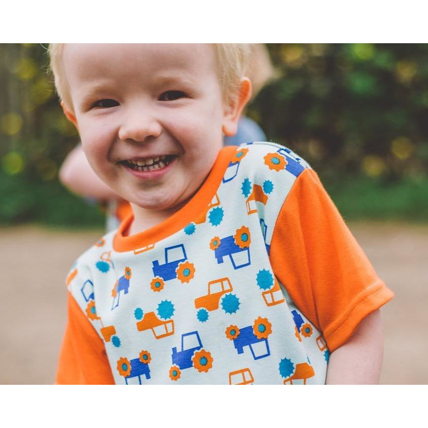 Little Boy wearing Orange & Aqua Tractor T-shirt by Toucan Blue | Cotswold Baby co 