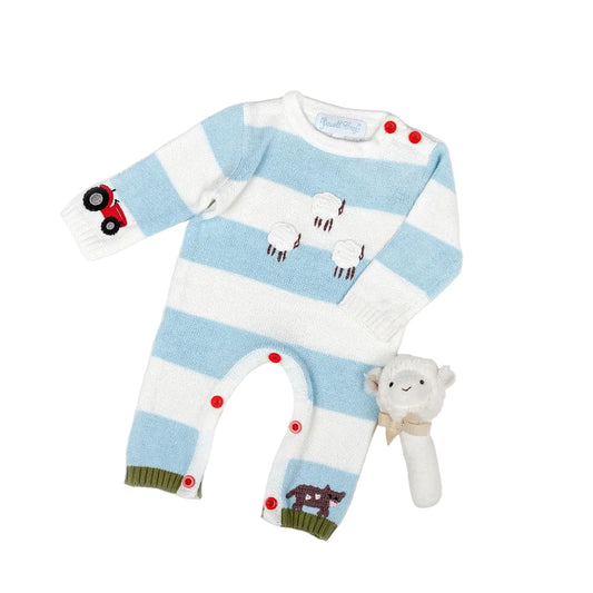 A baby playsuit featuring a knitted farmyard scene with sheep, a cow, and a tractor, along with red buttons and striped patterns.